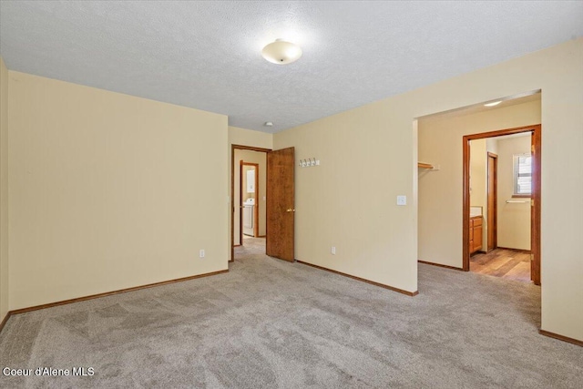 879 E Cloverleaf Dr, Hayden, ID 83835 - unfurnished bedroom with carpet flooring, a textured ceiling, and washer / dryer