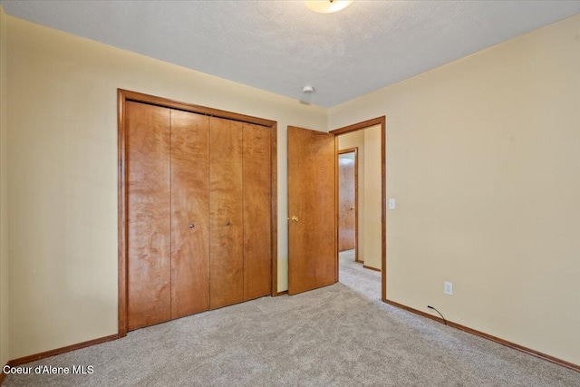 879 E Cloverleaf Dr, Hayden, ID 83835 - unfurnished bedroom with light colored carpet and a closet