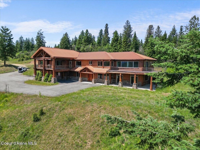 5239 E Dodd Rd, Hayden, ID 83835 - view of front of property with stone siding, driveway, a front lawn, and a metal roof