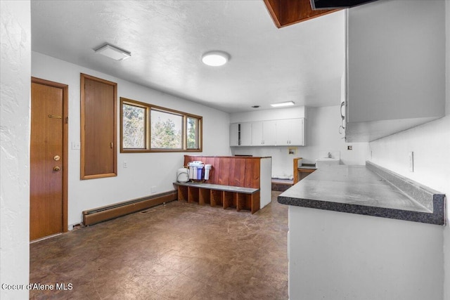 5239 E Dodd Rd, Hayden, ID 83835 - kitchen featuring baseboard heating, white cabinets, dark countertops, and dark flooring