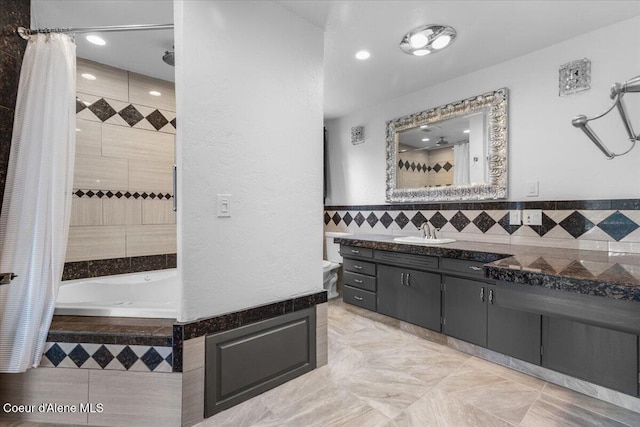 5239 E Dodd Rd, Hayden, ID 83835 - full bathroom featuring tiled bath, vanity, a tile shower, tile walls, and recessed lighting