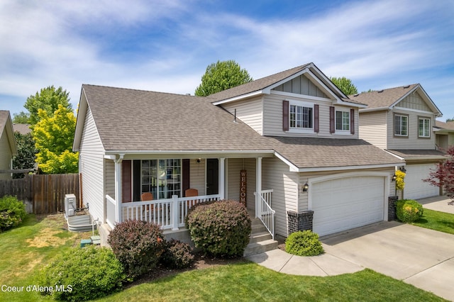 1817 N Chehalis St, Post Falls, ID 83854 - traditional-style house with covered porch, an attached garage, a shingled roof, concrete driveway, and board and batten siding