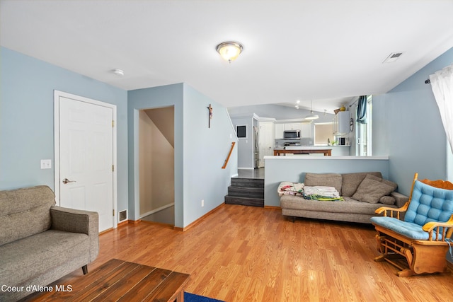1817 N Chehalis St, Post Falls, ID 83854 - living area with light wood-style flooring and stairs