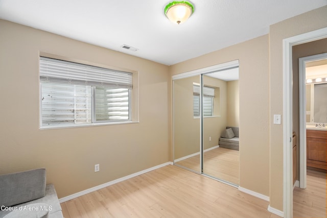 1817 N Chehalis St, Post Falls, ID 83854 - unfurnished bedroom featuring light wood-style flooring, a closet, and multiple windows