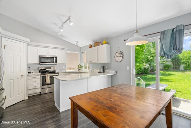 1817 N Chehalis St, Post Falls, ID 83854 - kitchen with appliances with stainless steel finishes, lofted ceiling, track lighting, white cabinetry, and light countertops