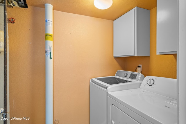 1817 N Chehalis St, Post Falls, ID 83854 - laundry room featuring cabinet space, washer and dryer, and a textured wall