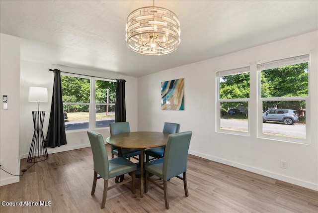 202 S 18th St, Coeur Dalene, ID 83814 - dining space featuring light wood-style flooring, a chandelier, and plenty of natural light