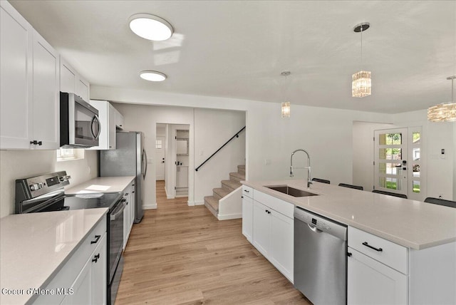 202 S 18th St, Coeur Dalene, ID 83814 - kitchen with appliances with stainless steel finishes, white cabinetry, plenty of natural light, and light wood-style flooring