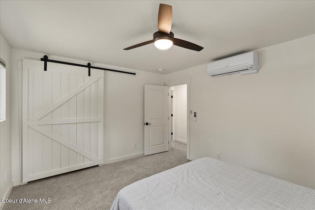 202 S 18th St, Coeur Dalene, ID 83814 - bedroom with a wall mounted AC, carpet floors, a barn door, and ceiling fan
