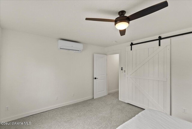 202 S 18th St, Coeur Dalene, ID 83814 - unfurnished bedroom featuring a wall unit AC, carpet flooring, a ceiling fan, and a barn door