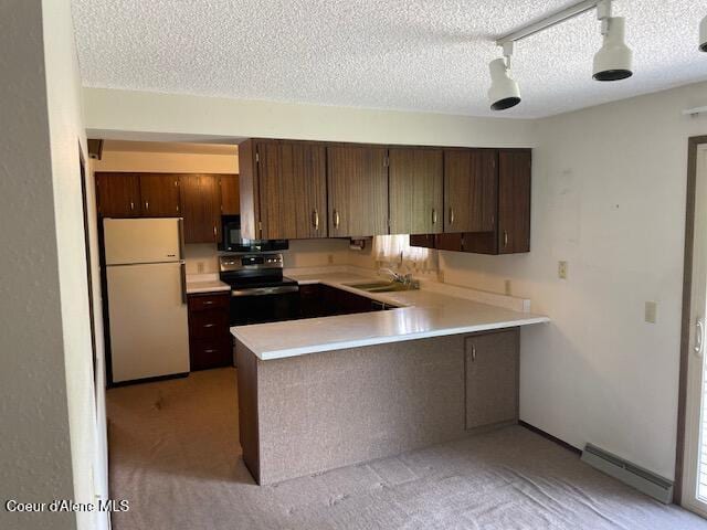 204 W Oak Ave, Osburn, ID 83849 - kitchen with freestanding refrigerator, light countertops, light carpet, a peninsula, and black range with electric cooktop