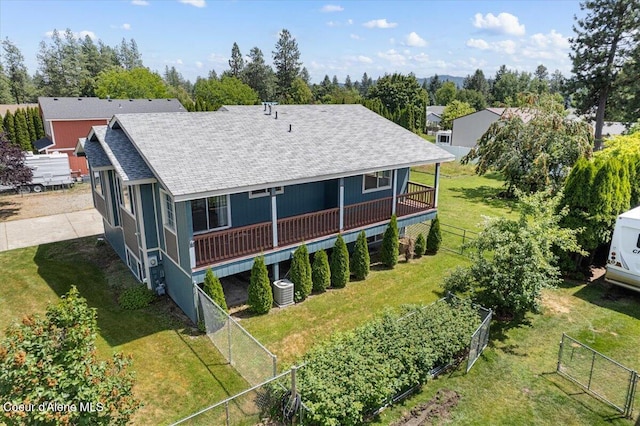401 W 19th Ave, Post Falls, ID 83854 - back of house with a shingled roof, a vegetable garden, a fenced backyard, and a deck