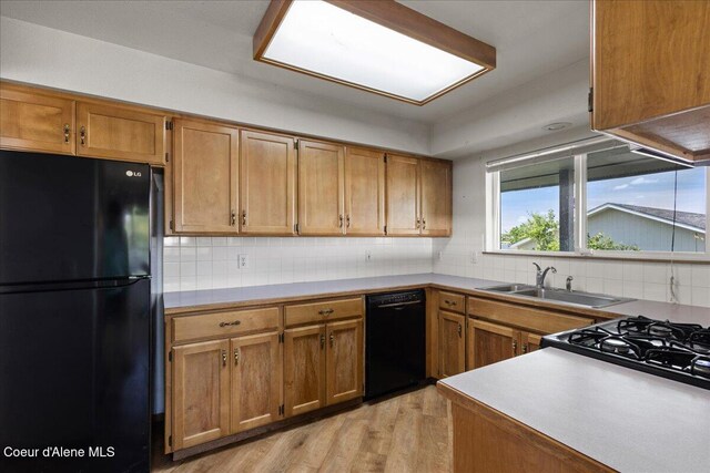 401 W 19th Ave, Post Falls, ID 83854 - kitchen with black appliances, tasteful backsplash, and brown cabinets