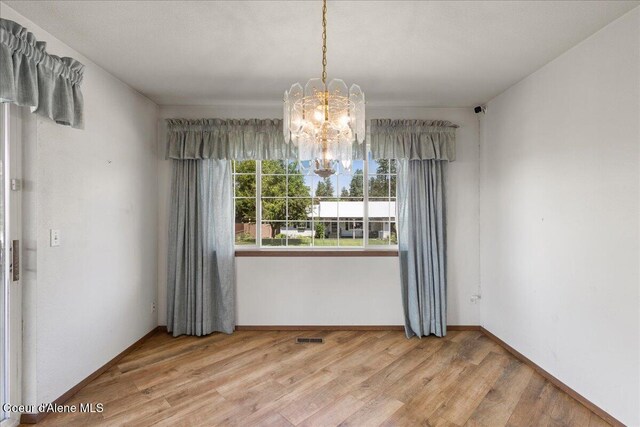 401 W 19th Ave, Post Falls, ID 83854 - unfurnished room featuring a chandelier and wood finished floors