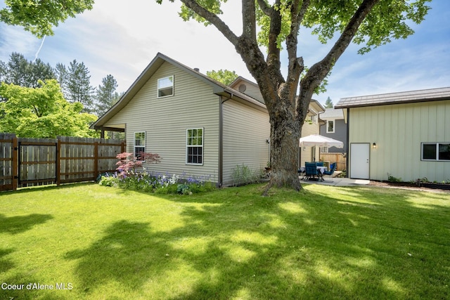 303 S 19th St, Coeur Dalene, ID 83814 - back of house featuring a patio area and board and batten siding