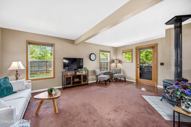 303 S 19th St, Coeur Dalene, ID 83814 - living area featuring a wood stove, plenty of natural light, carpet flooring, and beamed ceiling