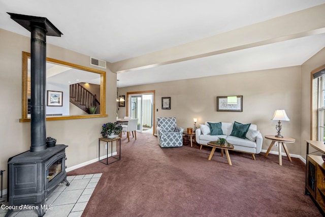 303 S 19th St, Coeur Dalene, ID 83814 - living area featuring a wood stove, carpet, healthy amount of natural light, and stairway