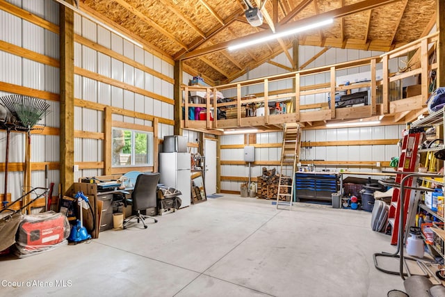 303 S 19th St, Coeur Dalene, ID 83814 - garage featuring freestanding refrigerator and a garage door opener