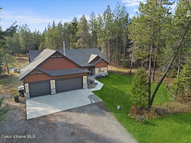 2130 E Bellamy Rd, Athol, ID 83801 - view of front of home with stone siding, driveway, board and batten siding, a front lawn, and a garage