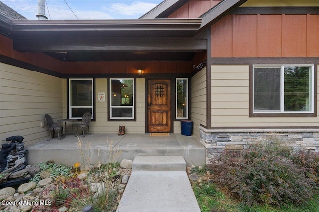 2130 E Bellamy Rd, Athol, ID 83801 - entrance to property with covered porch, stone siding, and board and batten siding