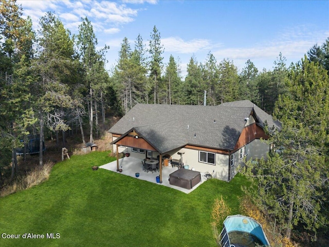 2130 E Bellamy Rd, Athol, ID 83801 - back of property featuring a yard, a patio area, a forest view, and roof with shingles