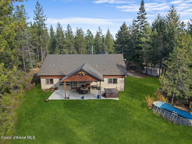 2130 E Bellamy Rd, Athol, ID 83801 - rear view of house with a patio, a yard, a gazebo, a covered pool, and a view of trees