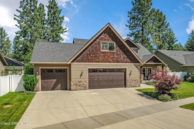 1431 W Ashmont Way, Coeur Dalene, ID 83815 - craftsman-style home with concrete driveway, stone siding, an attached garage, and a shingled roof