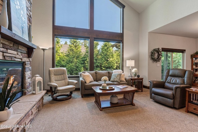 1431 W Ashmont Way, Coeur Dalene, ID 83815 - living room with carpet floors, a towering ceiling, and a fireplace