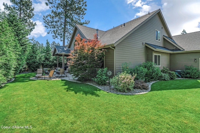 1431 W Ashmont Way, Coeur Dalene, ID 83815 - view of side of property with a patio area, roof with shingles, and a lawn