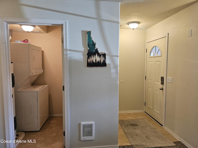 848 N Chase Rd # 102, Post Falls, ID 83854 - washroom featuring stacked washer / dryer and baseboards