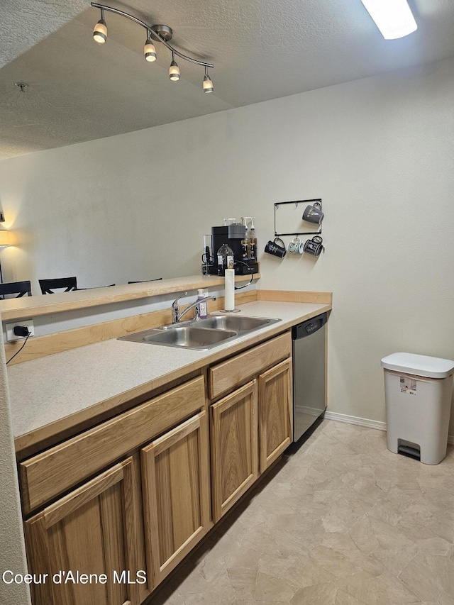 848 N Chase Rd # 102, Post Falls, ID 83854 - kitchen with dishwasher, light countertops, brown cabinets, and a textured ceiling