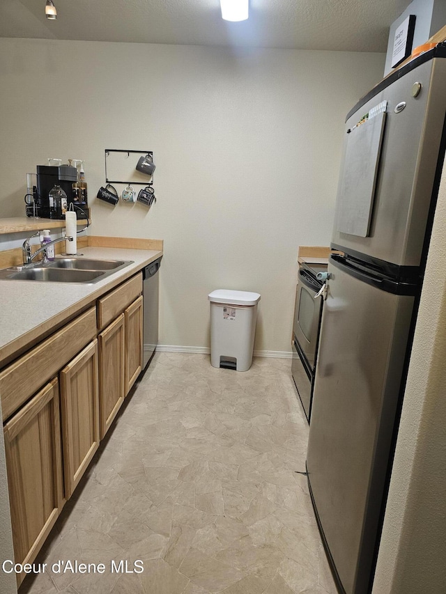 848 N Chase Rd # 102, Post Falls, ID 83854 - kitchen with appliances with stainless steel finishes, light countertops, and brown cabinetry