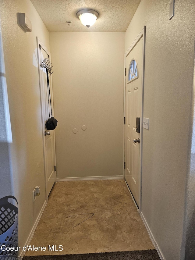 848 N Chase Rd # 102, Post Falls, ID 83854 - doorway to outside with a textured ceiling