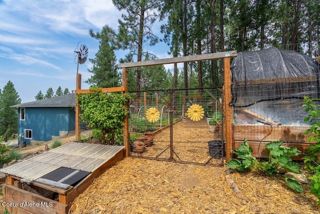 18914 W Riverview Dr, Post Falls, ID 83854 - view of patio / terrace with an outdoor structure, a garden, and exterior structure