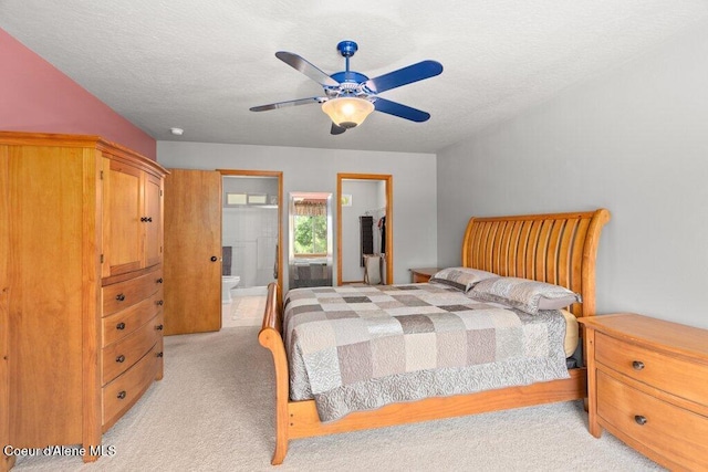 18914 W Riverview Dr, Post Falls, ID 83854 - bedroom with light carpet, ensuite bath, ceiling fan, and a textured ceiling