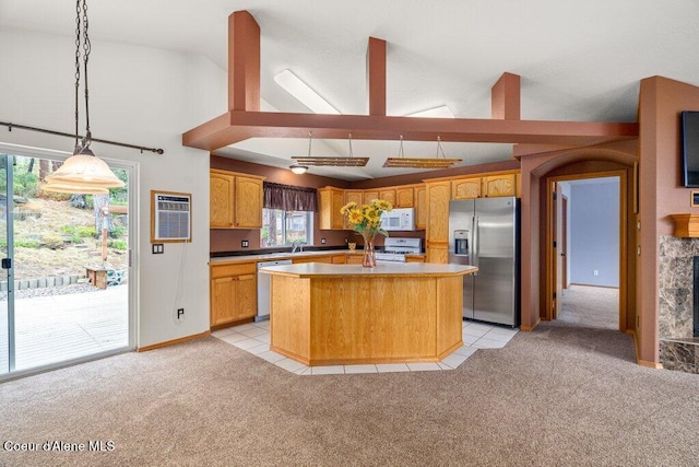18914 W Riverview Dr, Post Falls, ID 83854 - kitchen with stainless steel appliances, light colored carpet, a center island, decorative light fixtures, and light countertops