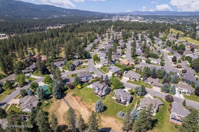 740 N Dundee Dr, Post Falls, ID 83854 - aerial overview of property's location with a mountainous background and nearby suburban area