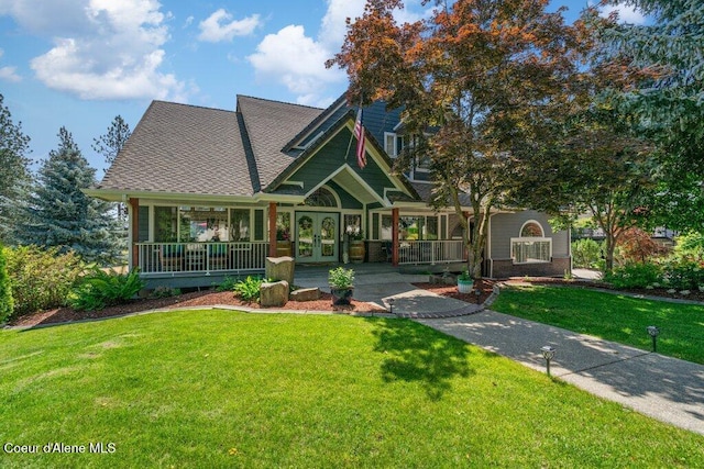 740 N Dundee Dr, Post Falls, ID 83854 - view of front of property with a front yard, french doors, covered porch, and a shingled roof