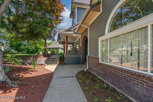 740 N Dundee Dr, Post Falls, ID 83854 - view of home's exterior featuring brick siding and a porch