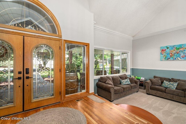 740 N Dundee Dr, Post Falls, ID 83854 - living area with vaulted ceiling, wood finished floors, a textured ceiling, and ornamental molding