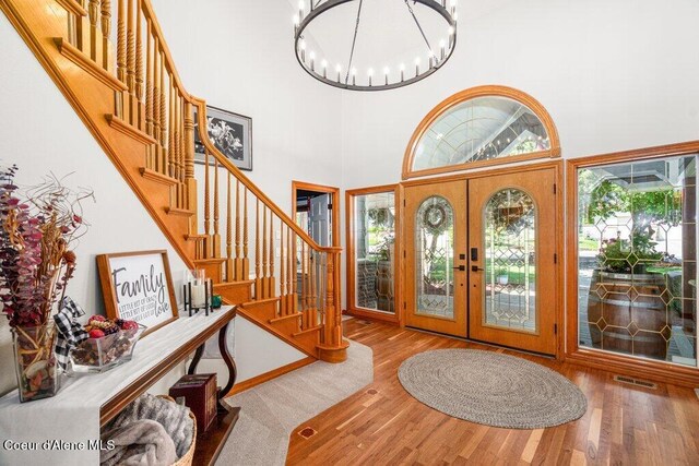 740 N Dundee Dr, Post Falls, ID 83854 - foyer entrance with wood finished floors, stairway, french doors, a chandelier, and a high ceiling