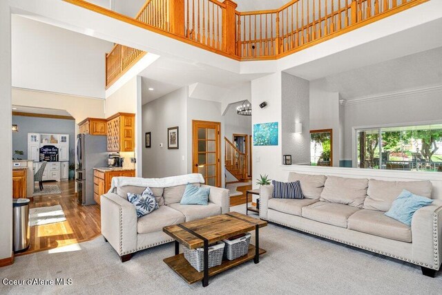 740 N Dundee Dr, Post Falls, ID 83854 - living room featuring stairs, a high ceiling, wood finished floors, and carpet floors
