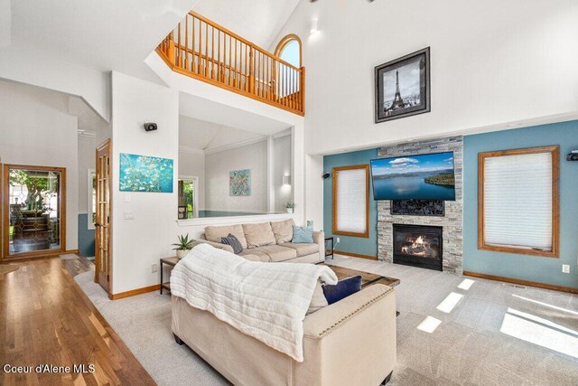 740 N Dundee Dr, Post Falls, ID 83854 - living area with a high ceiling, plenty of natural light, a stone fireplace, and carpet