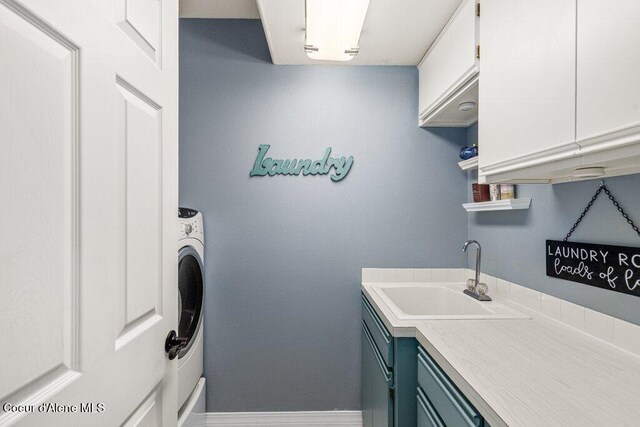 740 N Dundee Dr, Post Falls, ID 83854 - laundry area featuring cabinet space and washer / clothes dryer