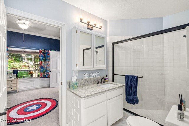 740 N Dundee Dr, Post Falls, ID 83854 - full bathroom with vanity, a shower stall, and ceiling fan