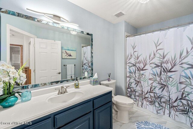 740 N Dundee Dr, Post Falls, ID 83854 - full bathroom featuring vanity, marble look tile flooring, and a shower with shower curtain