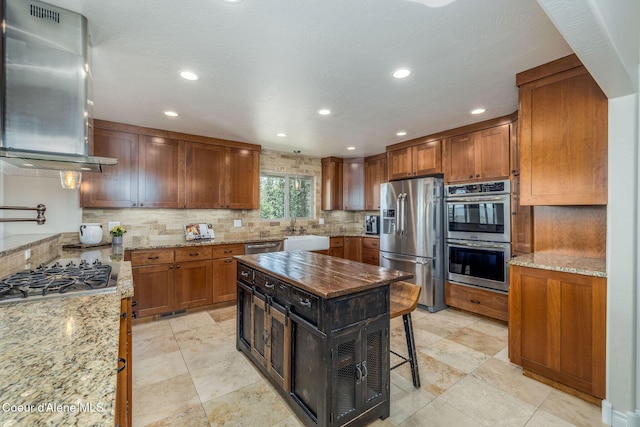 8718 W Sausser Dr, Coeur Dalene, ID 83814 - kitchen with appliances with stainless steel finishes, ventilation hood, tasteful backsplash, light stone countertops, and recessed lighting