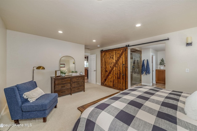 8718 W Sausser Dr, Coeur Dalene, ID 83814 - bedroom featuring a barn door, light colored carpet, and recessed lighting
