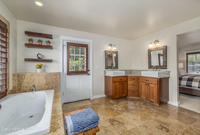 8718 W Sausser Dr, Coeur Dalene, ID 83814 - bathroom featuring double vanity, plenty of natural light, a jetted tub, and connected bathroom