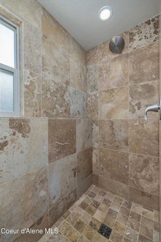 8718 W Sausser Dr, Coeur Dalene, ID 83814 - bathroom featuring tiled shower